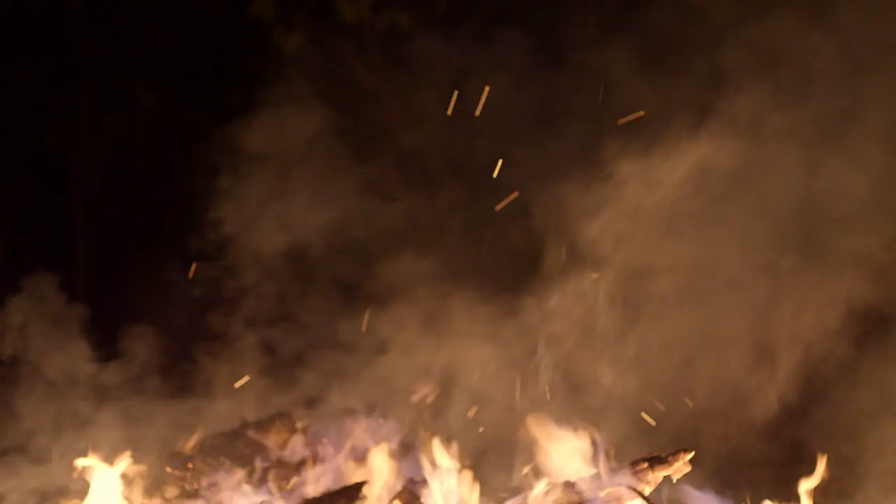 Shot of open fire burning with flames rising in the cold winter night at Christmas market winter wonderland