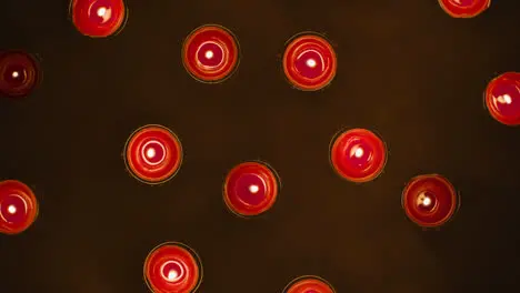 Overhead Shot Of Romantic Lit Red Candles Revolving On Black Background