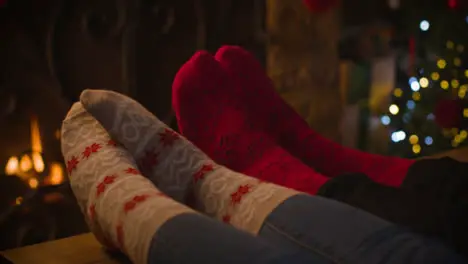 Close Up Shot of Couples Feet In Front of Cosy Warm Fireplace