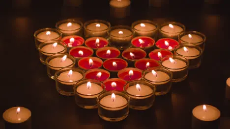 Romantic Red And White Candles In the Shape Of A Heart On Black Background 1