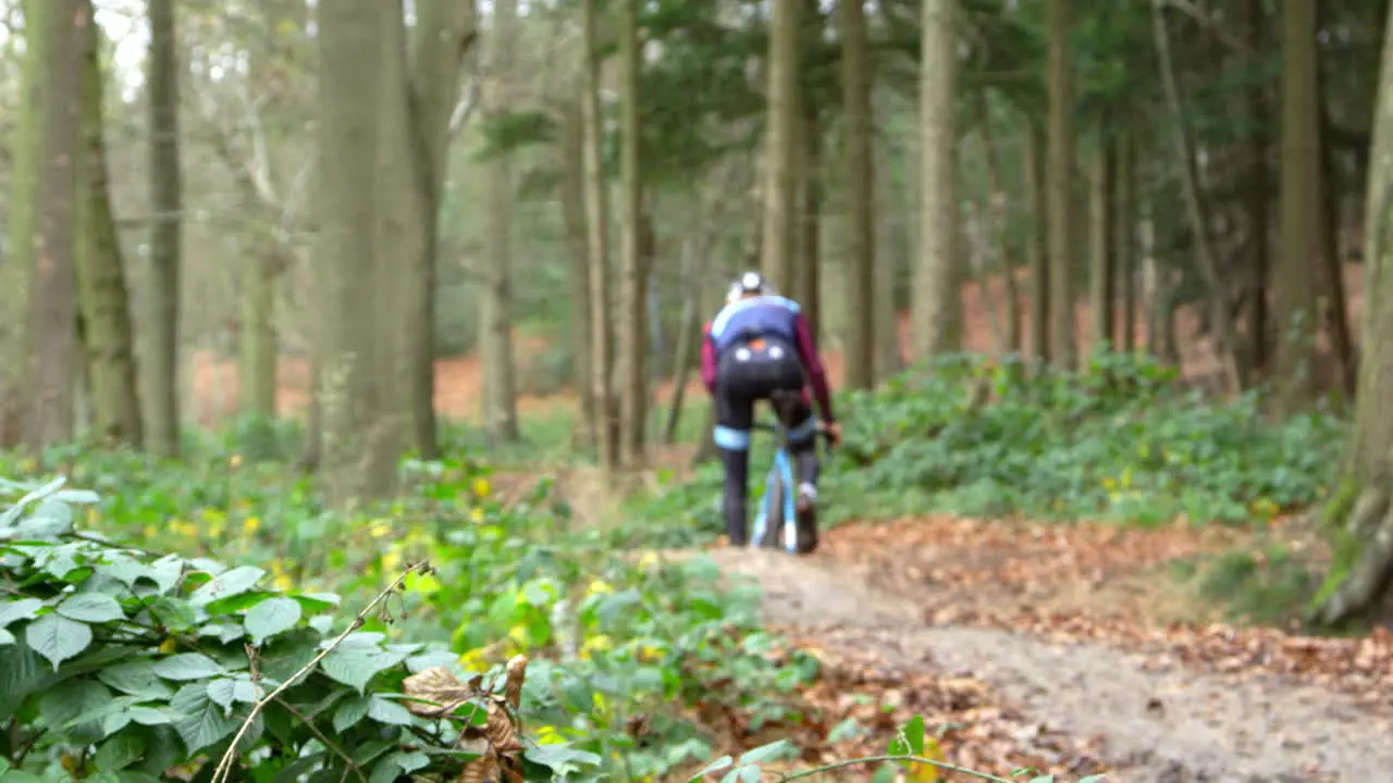 Man cross-country cycling splashes through a puddle shot on R3D