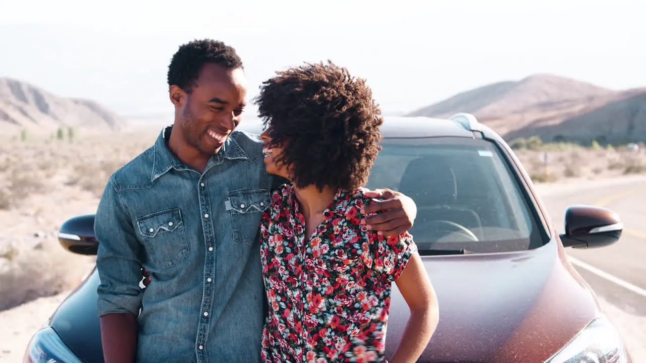 Happy black couple having a roadside stop off close up