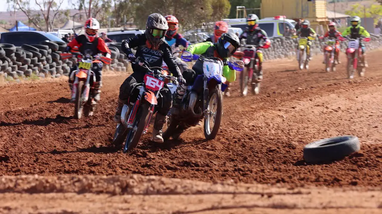 High resolution Motocross bikes racing into a corner with one bike almost crashing