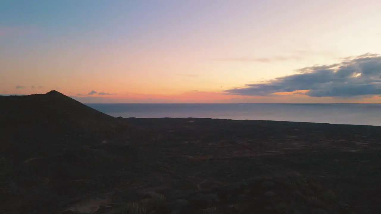 Upward Revealing Shot Over Mountain of Beautiful Orange and Blue Sunset