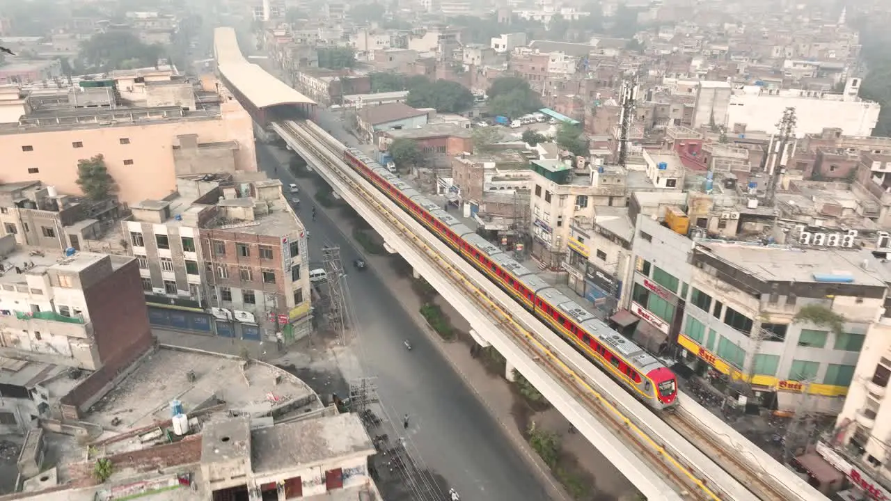 Aerial View Of Orange Line Metro Train Departing Station Near McLeod Road In Lahore On Elevated Track