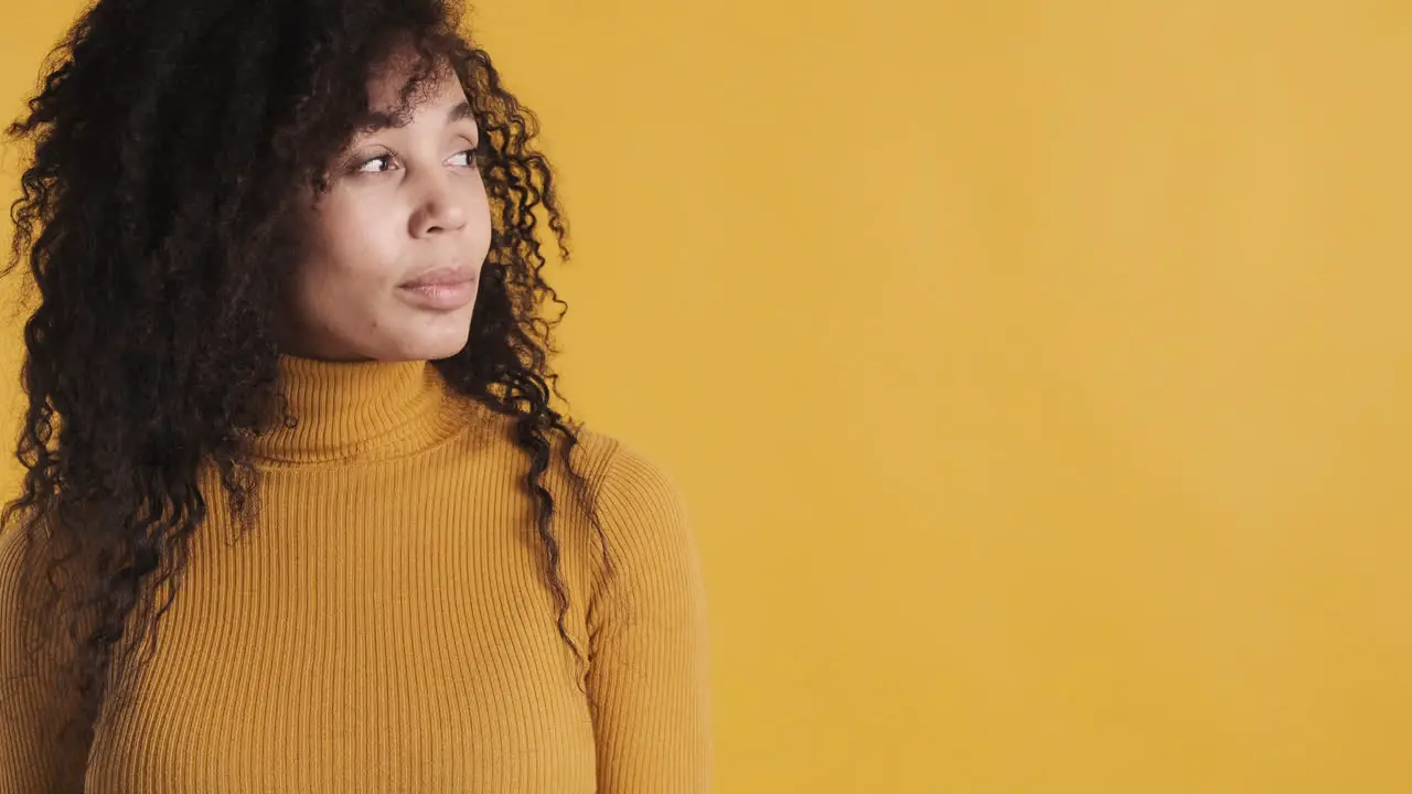 African american smiling woman over orange background