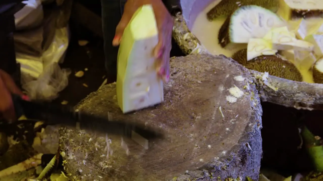 man chopping fresh organic unripe jack fruit for vegetable from farm close up shot