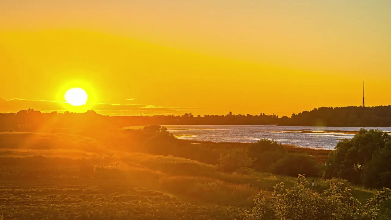 Golden Hour Sunset Over Lake And Rural Landscape With Beautiful Silhouette In Background