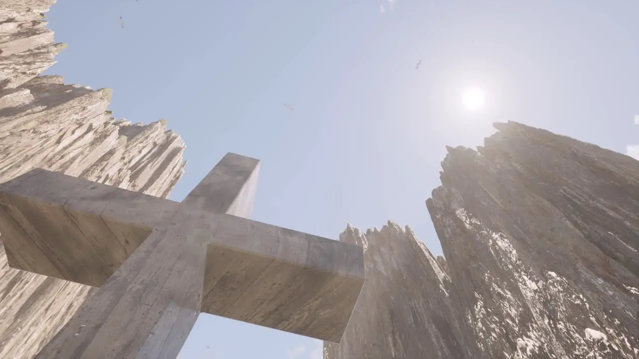 A large cross between huge steep cliffs with the sun shining above it 3D animation camera looking upwards to the sky