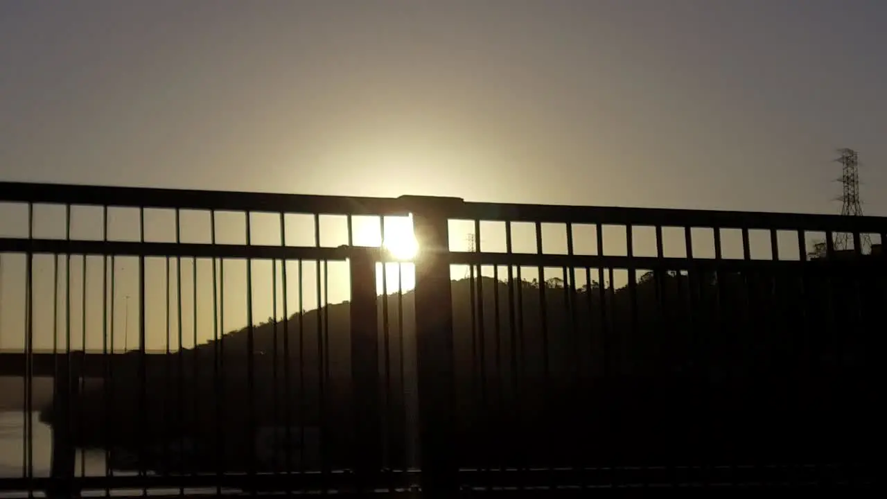 Driving over a bridge as the sun sets