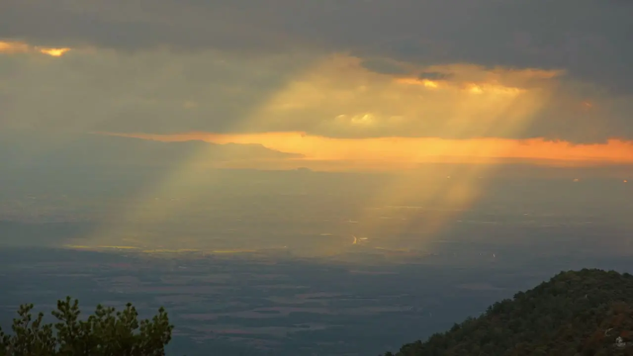 Light rays shining through clouds in Catalan mountain range Spain