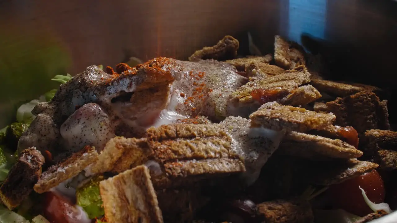 Close up of a spices being added to a bowl while preparing tuna salad