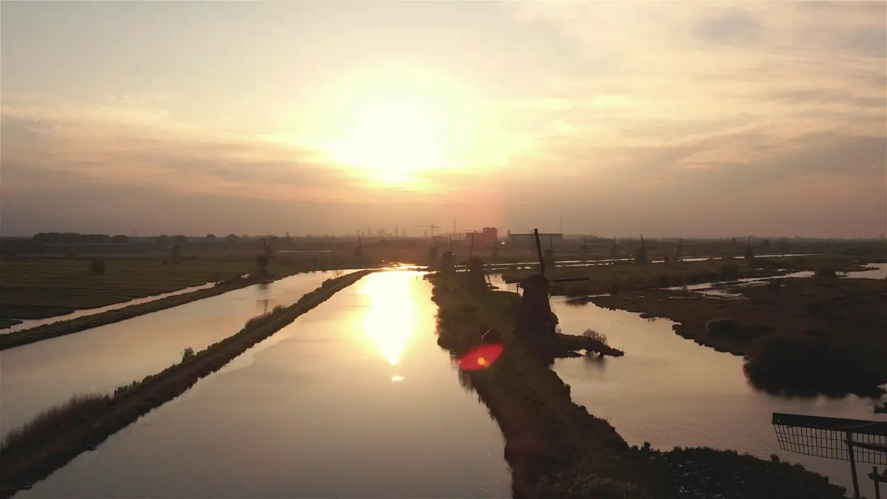 drone flight flying past the windmills of Kinderdijk at sunset in 4k