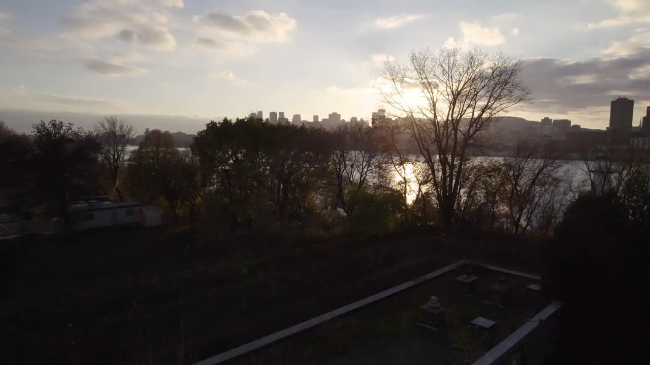 Slow reveal of Montreal city in the distance at sunset