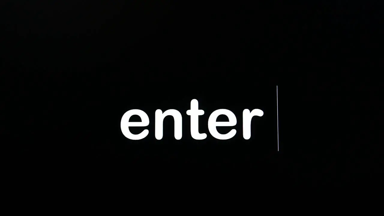 Writing on the screen with a flashing paragraph forming the word enter in white on a black background