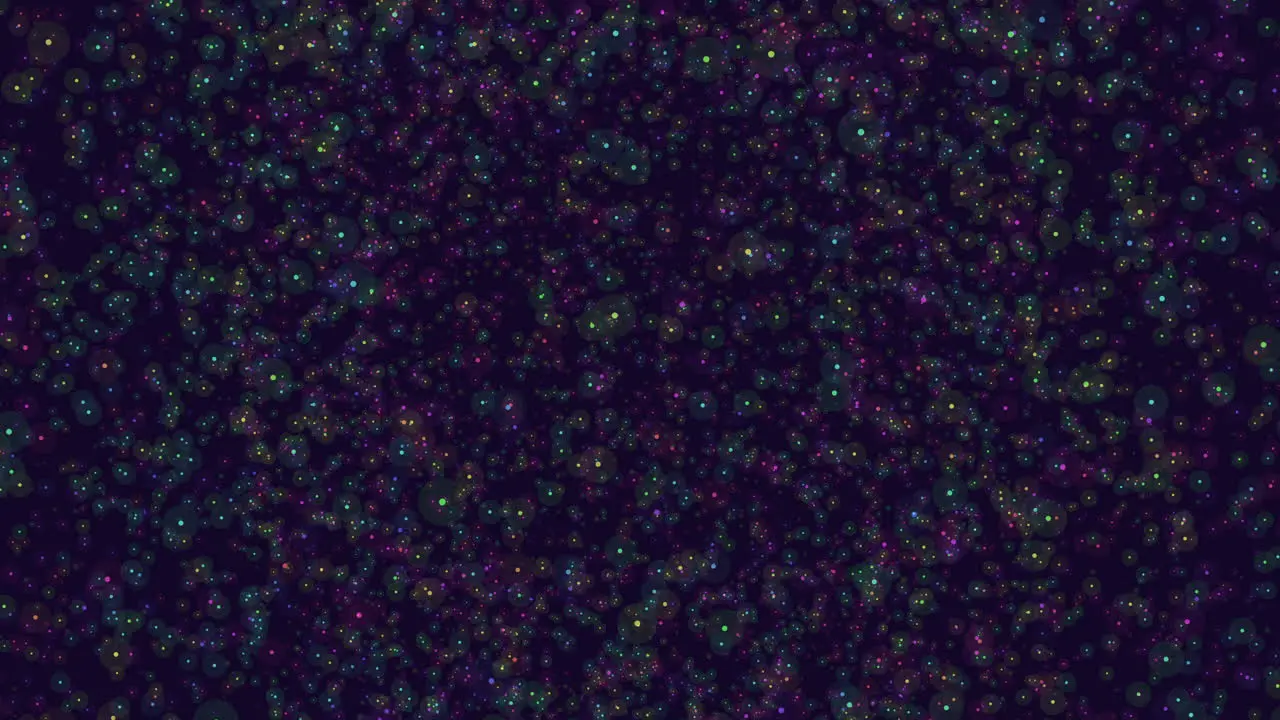 Colorful dots scatter on dark background