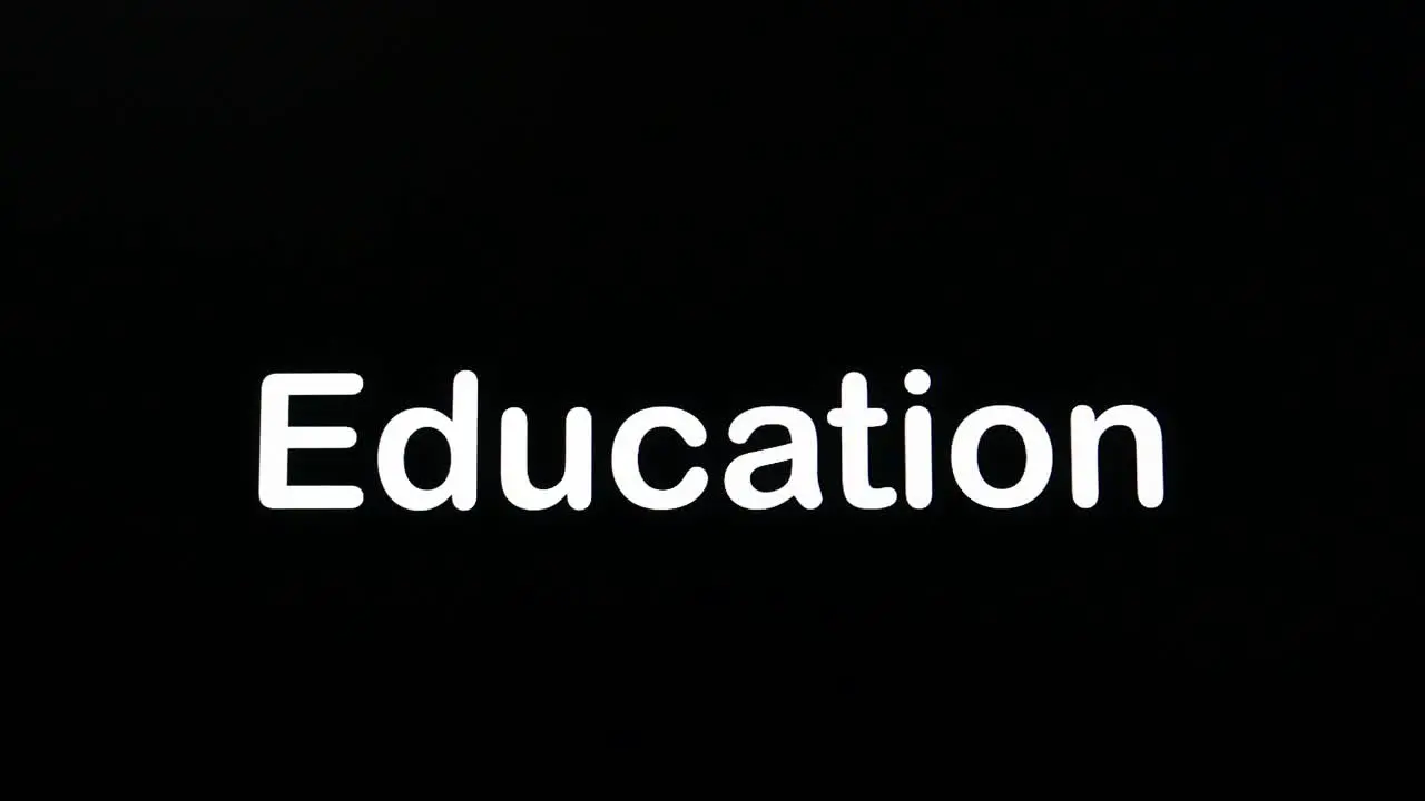 Typing on screen with black background written Education