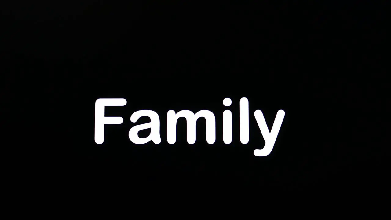 Typing on screen with black background written Family