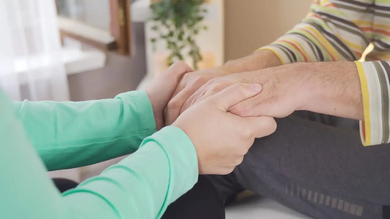 Nurse holding hands of female patientHealthcare support concept