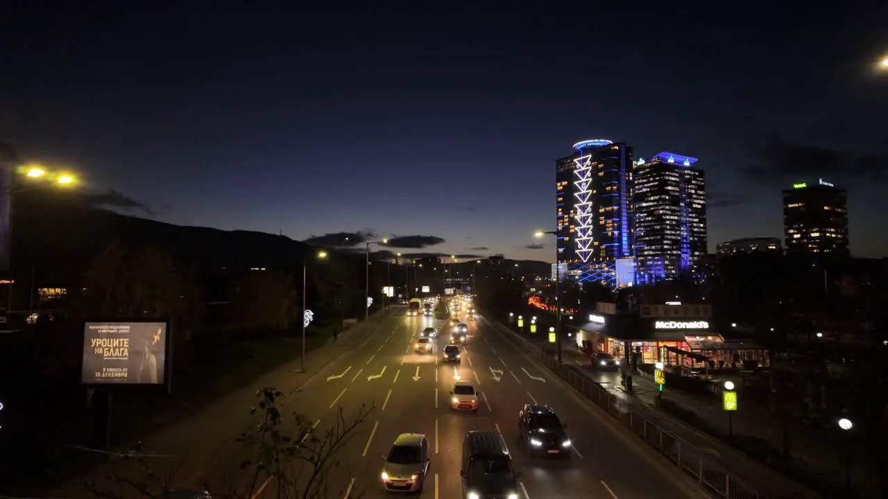 car traffic at 'Bulgaria Boulevard' at night McDonald's restaurant and high-rise buildings on the right