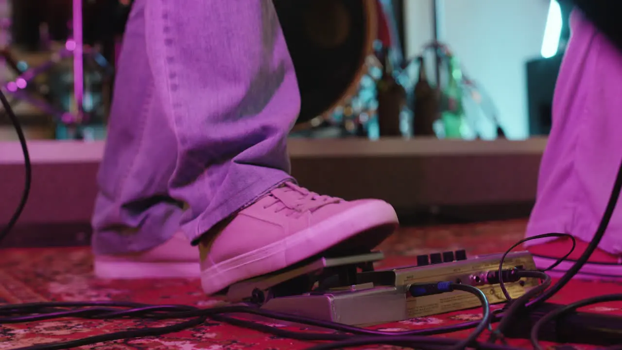 Close Up Of An Unrecognizable Musician's Foot Pressing Effects Pedal In Recording Studio