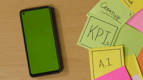 Business Concept Of Revolving Sticky Notes With Business And Financial Terms And Green Screen Mobile Phone 1