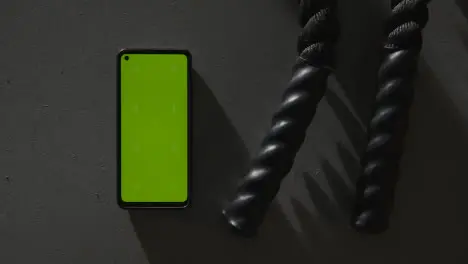 Overhead Studio Fitness Shot Of Hands Picking Up Gym Battle Ropes With Green Screen Mobile Phone On Grey Background 3