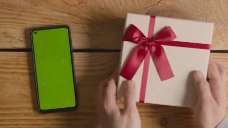 Overhead Shot Of Romantic Valentines Present In Gift Wrapped Box Next To Green Screen Mobile Phone 1