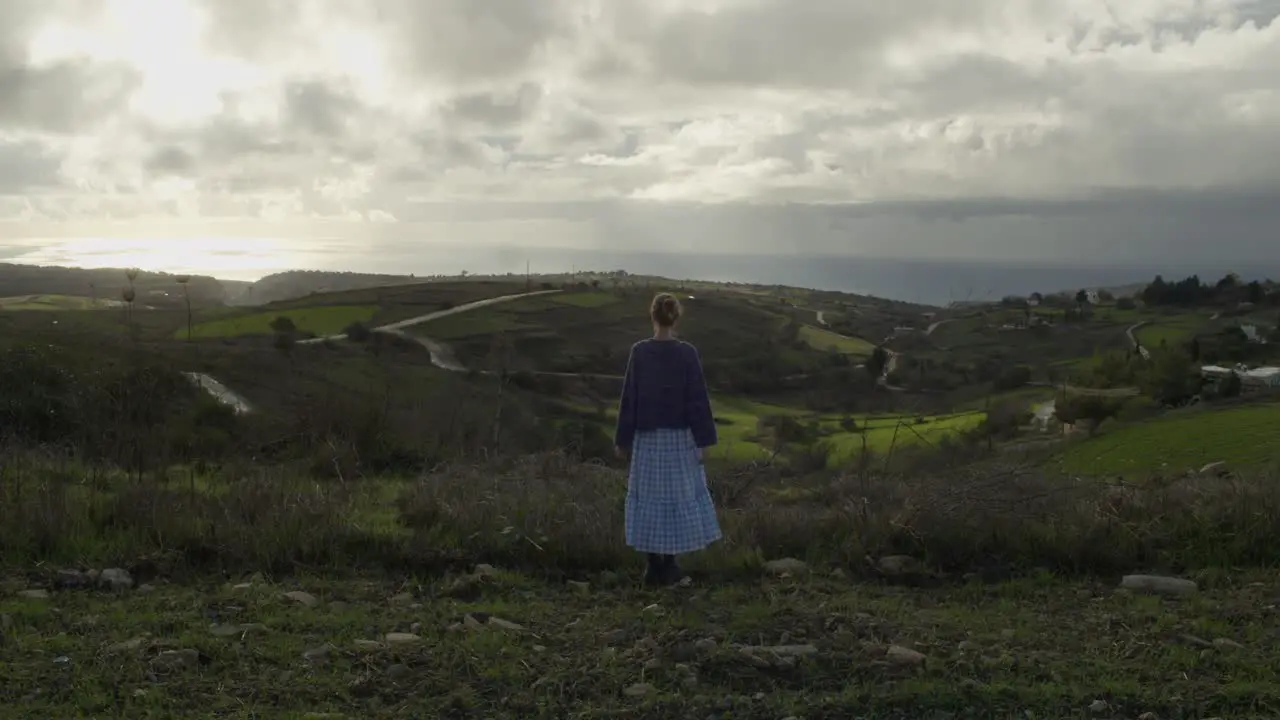 A Young Woman Looking at The Horizon and Mediterranean Sea in an Overcast Cyprus Countryside Slow Motion