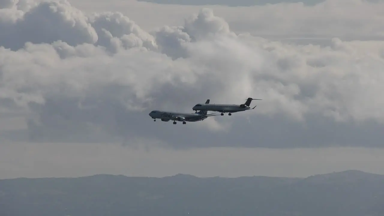 2 airplanes land side by side