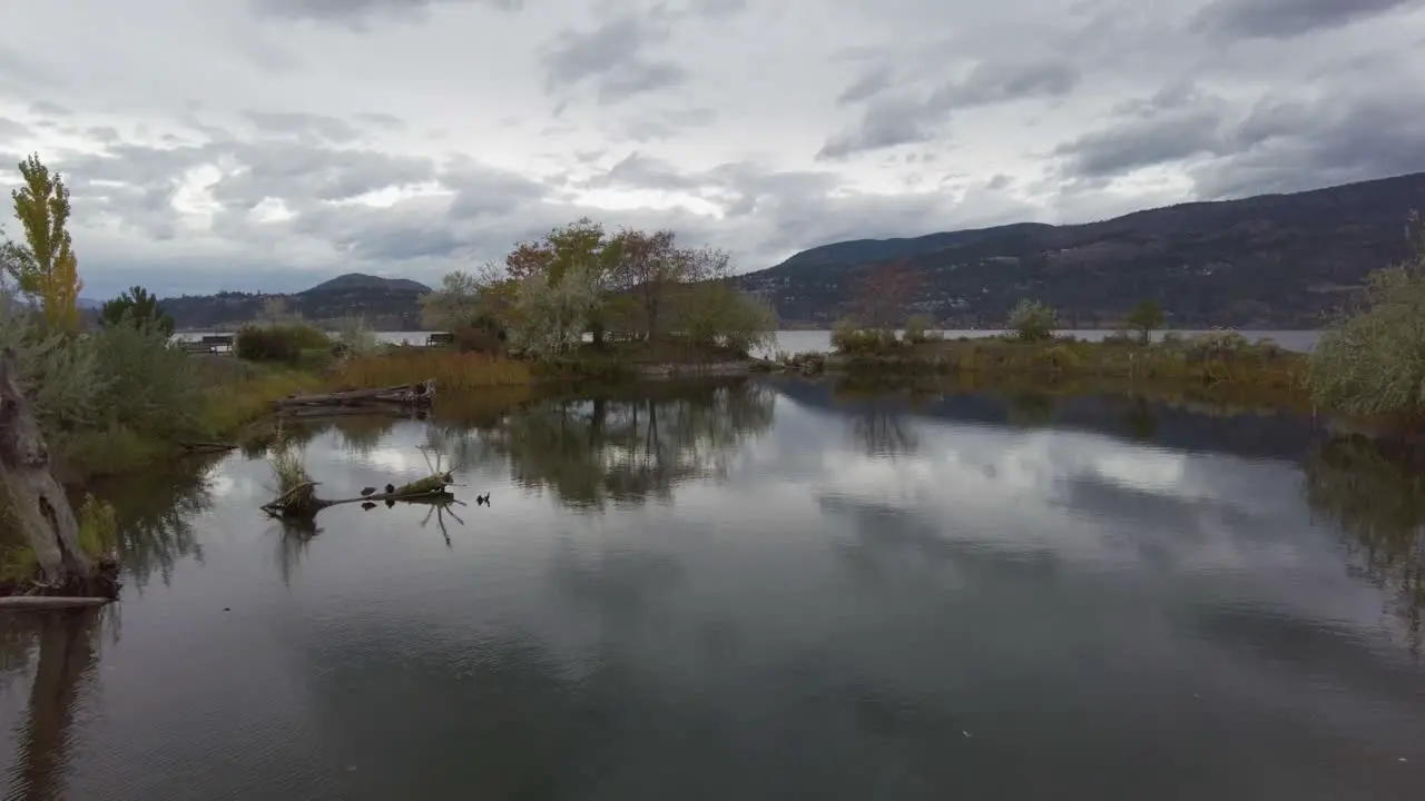 Panning Shot of Marsh and Lake Surrounded by Mountains