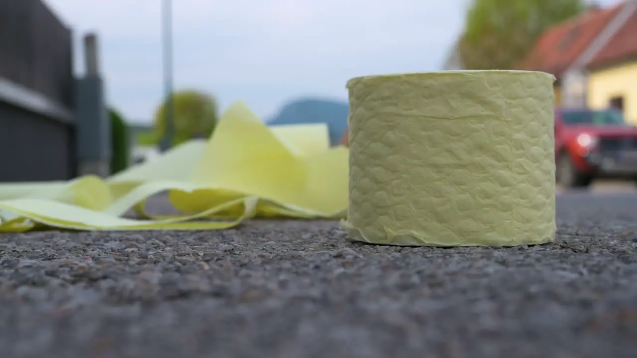 Toilet Paper landing on the Ground in Slow-Motion Close-Up Shot