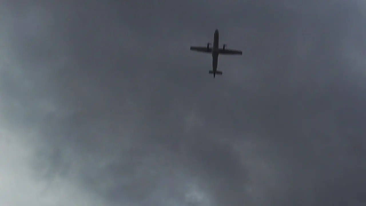 Plane Flying Overhead in a Dark Cloudy Sky