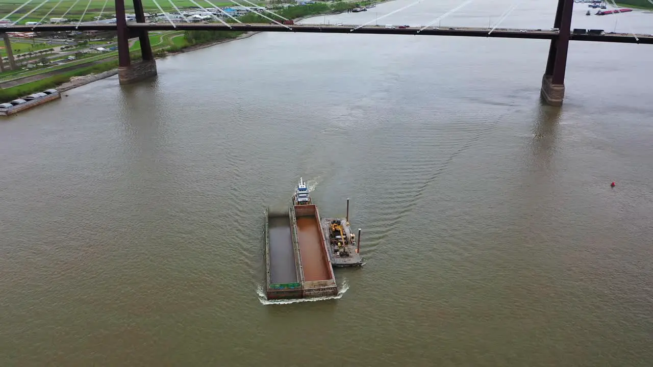 Working barges on the being pushed by a push boat on the Mississippi River in Louisiana