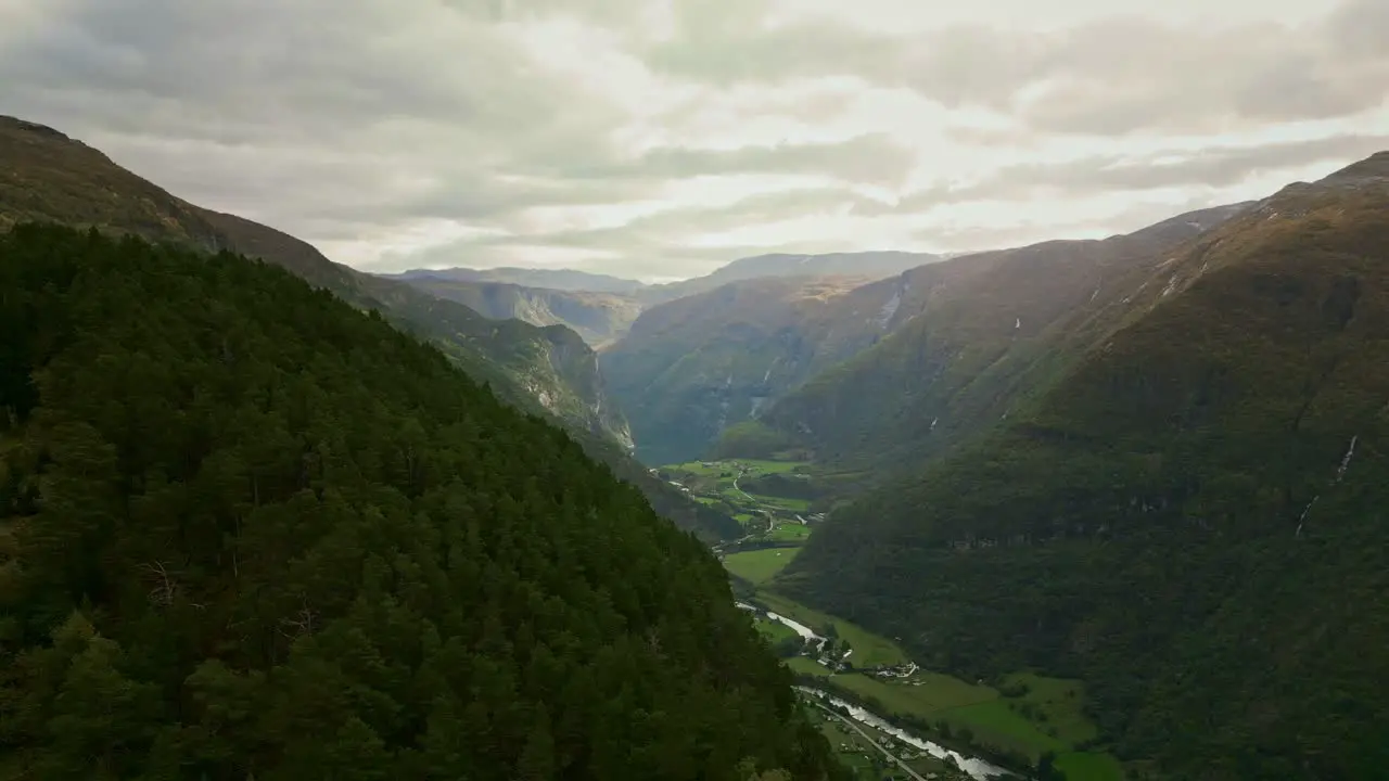 Drone flies through a valley in Norway in slightly cloudy weather