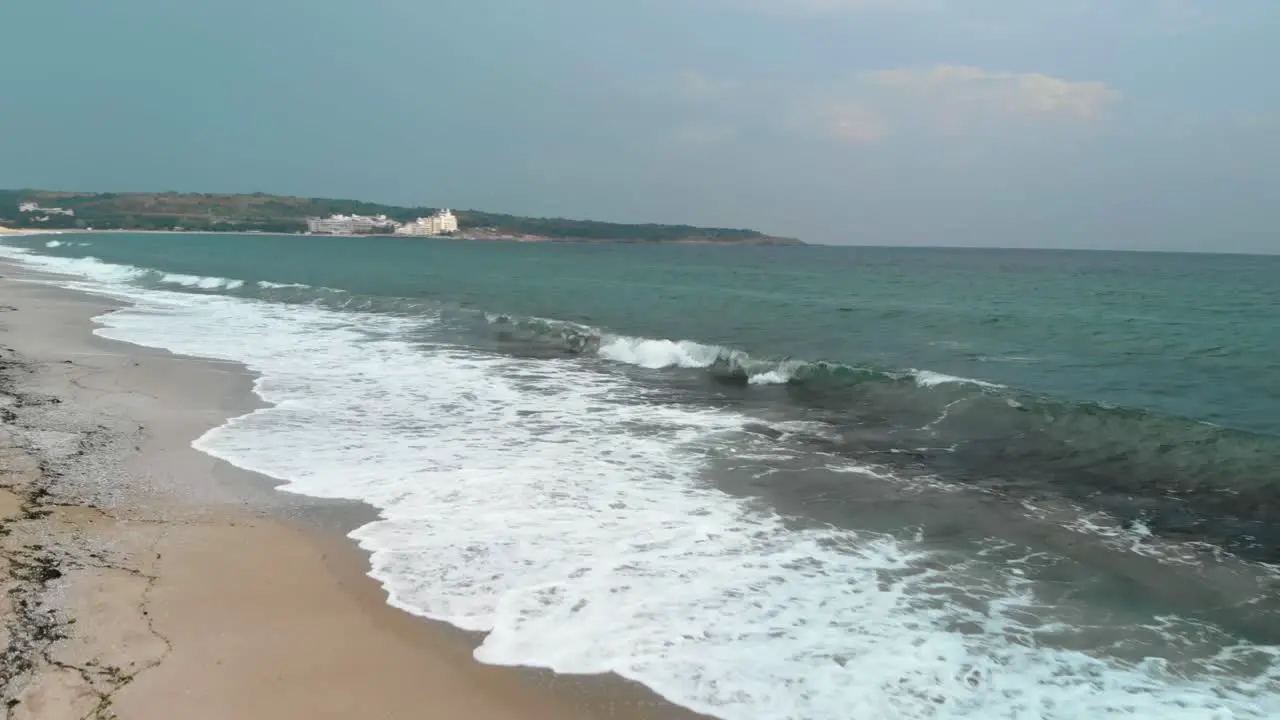 Drone seashore take off and turn left parallel the water in Sozopol Bulgaria