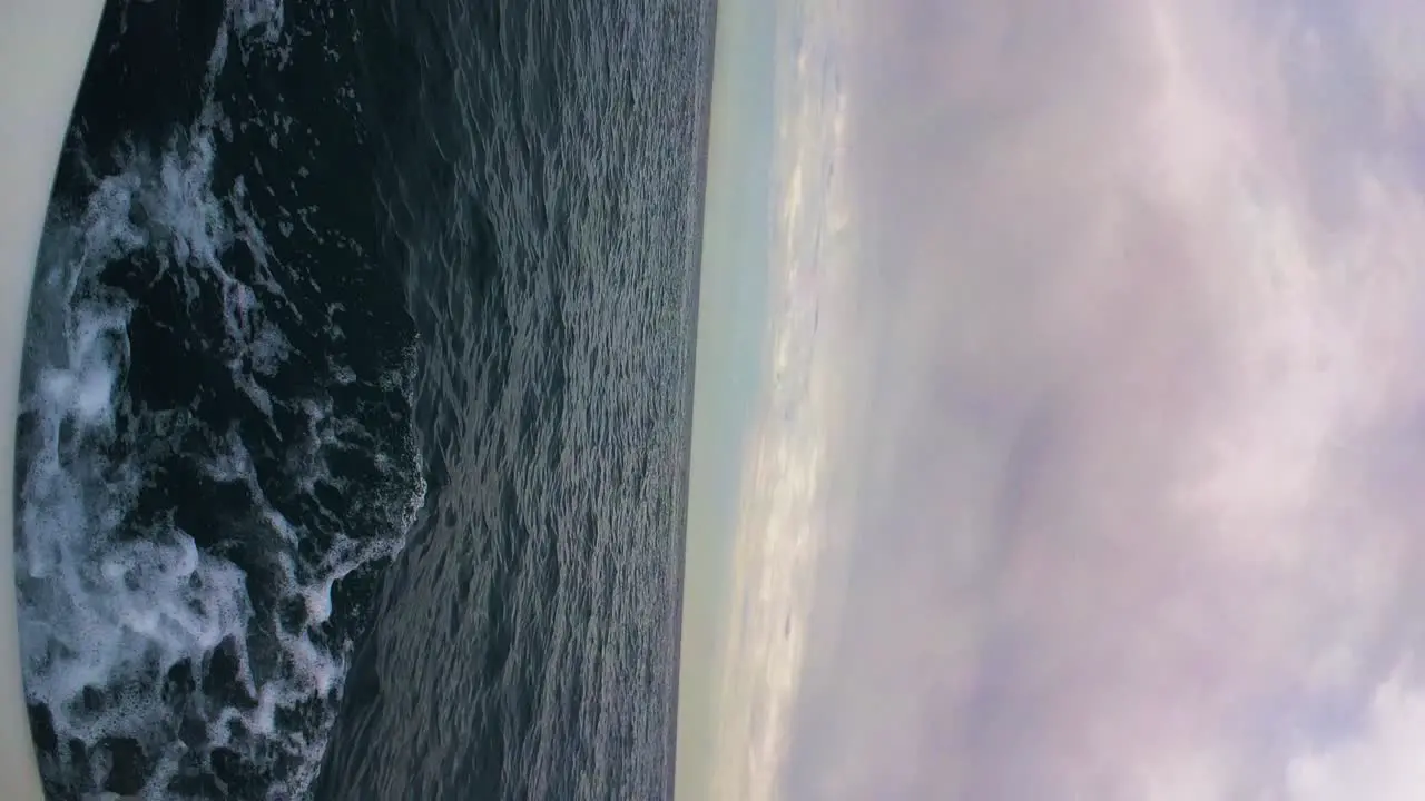 Sailing in open deep sea with moody cloudscape above vertical view