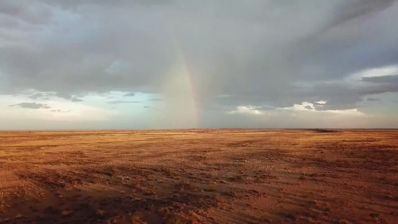 Drone shot of a rainbow in the distance on a very dry Namibian sheep farm