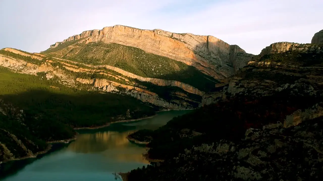 Water flowing between two mountain ridges green vegetation cover over foot of the mountain ridges in Barcelona