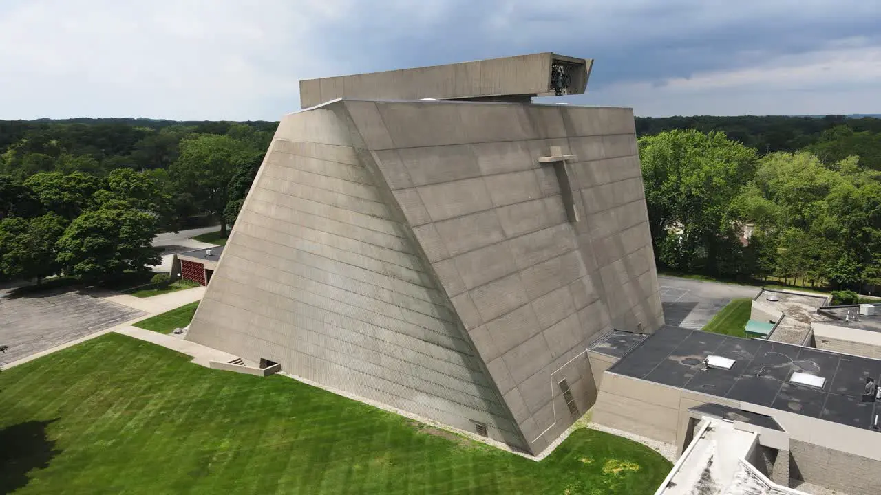 Storm clouds passing over the brutalist stone structure of Saint Francis church