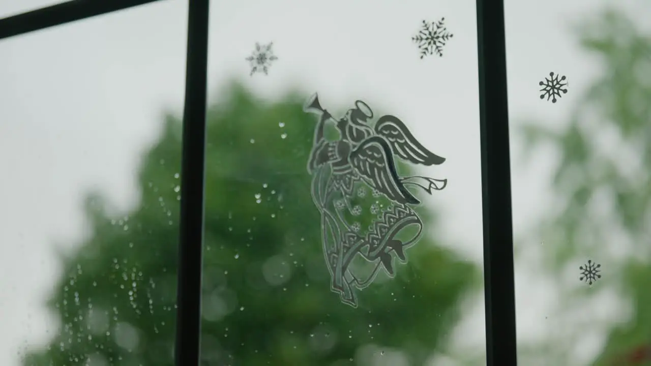 Image of Angel on the window as storm heavy winds blows outside in Stuttgart Germany Baden Wurttemberg Europe panning view angle