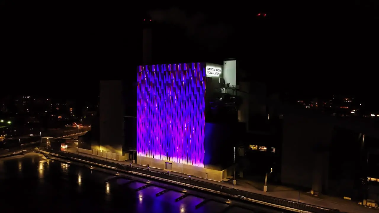 Aerial view approaching the illuminated NSL3 power plant night in Tampere Finland