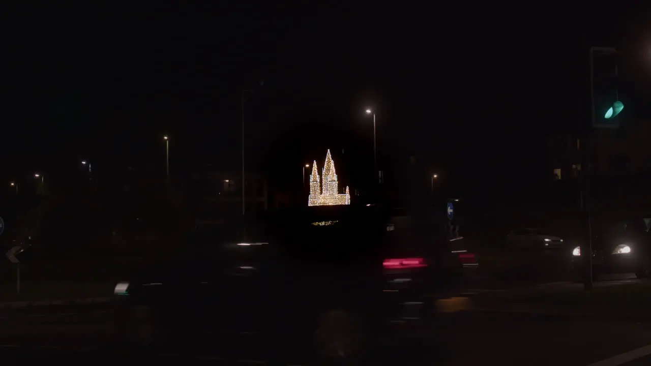 Cars Driving In The Street At Night With Cathedral-shaped Made From Christmas Lights In The Distance In Truro Cornwall UK