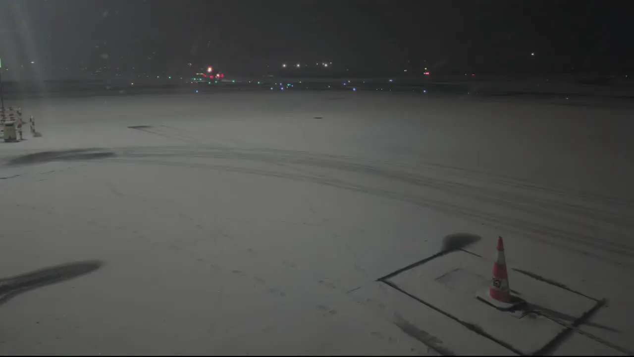 Fixed shot of empty airport ramp covered in snow