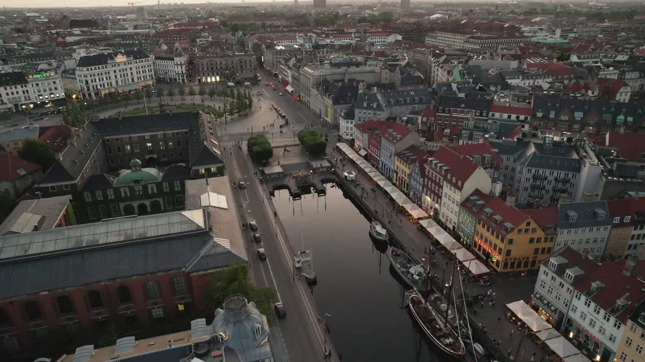 Nighttime Aerial Exploration of Kongens Nytorv and Nyhavn Revealing the Animated Cityscape with Welcoming Lighting and Crowds