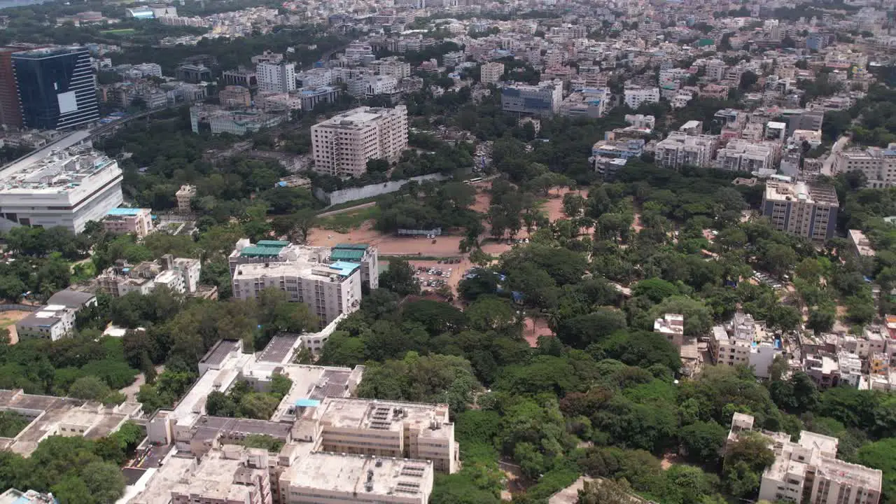 Aerial footage of India's urban residential and commercial centres in Hyderabad Telangana a house a terrace hotels and some trees are shown