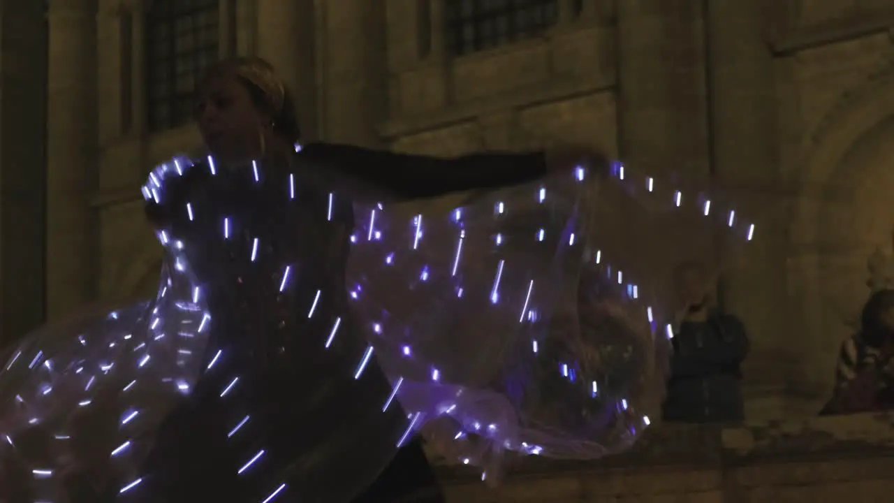 Woman perform a dance with LED wings at Lugo Medieval Festival Hypnotic glow motion