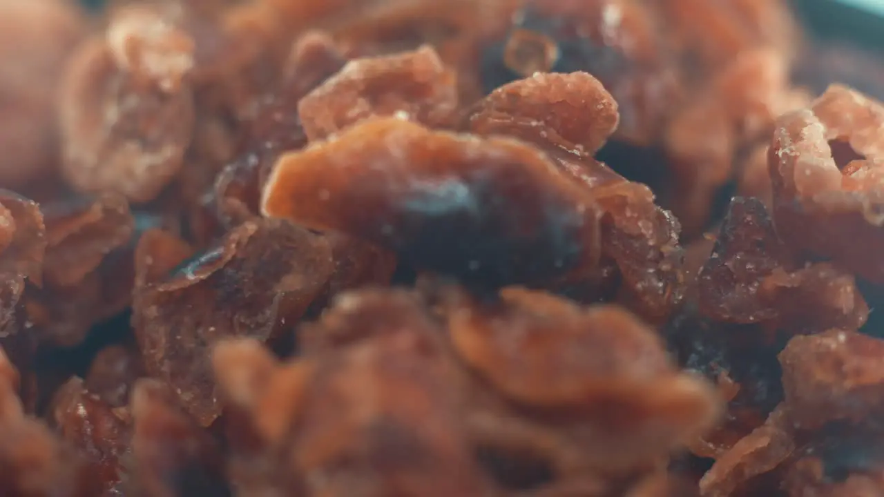 A macro close up shot of a pile of dried cranberries in a bawl on a rotating stand slow motion 4k