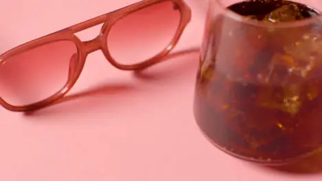 Summer Holiday Concept Of Sunglasses And Cold Drink On Pink Background 3