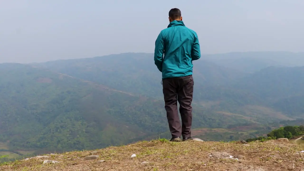 man alone at mountain rock with white mist background from flat angle